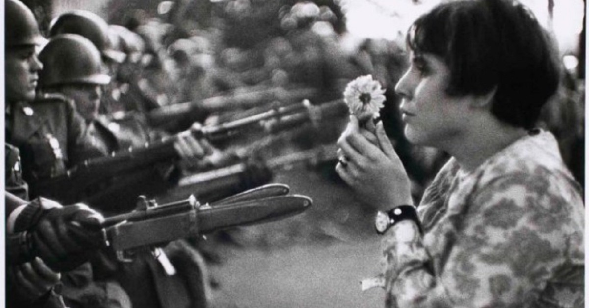 marc-riboud-girl-offering-a-flower-to-the-soldiers