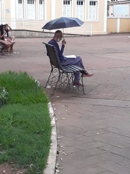 Homem é flagrado lendo sozinho na chuva e viraliza nas redes revistapazes.com - Homem é flagrado lendo sozinho na chuva e viraliza nas redes